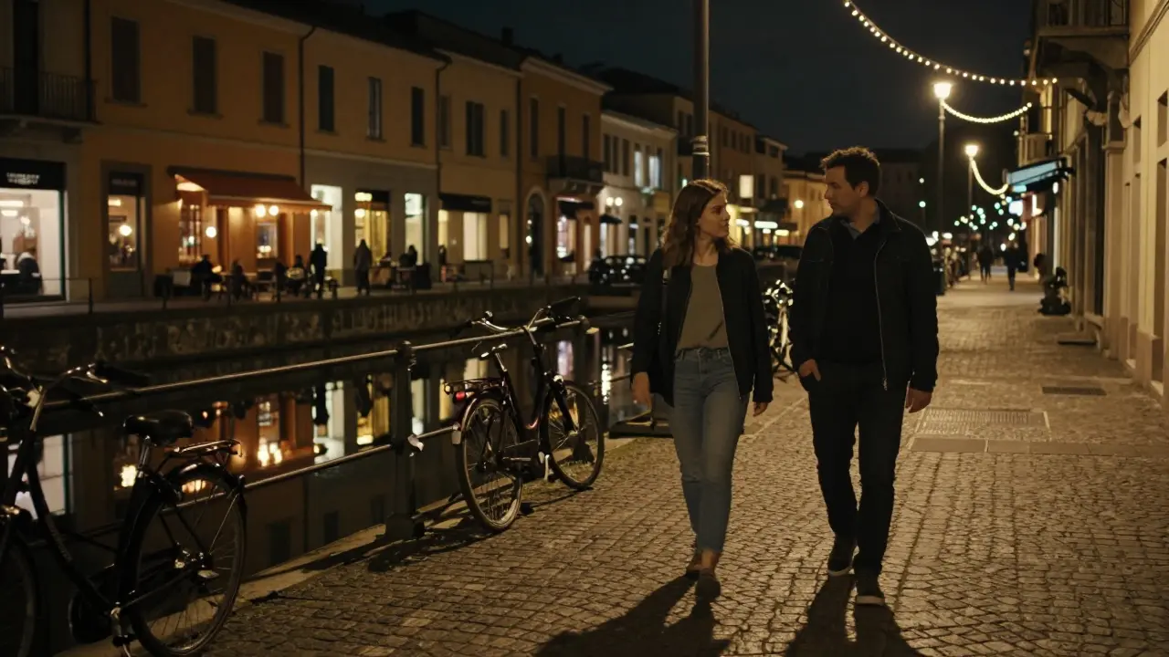 A man and woman walking peacefully along Milan's Navigli canal at night under string lights.