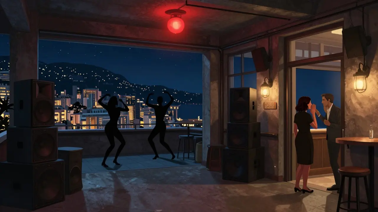 Rooftop club with dancers under a red light, city skyline behind, no signs or bouncers.