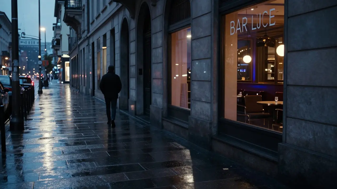 Quiet Milan street at 3 a.m. with a lone walker and the glowing window of Bar Luce in the distance.
